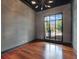 Office featuring hardwood floors, dark trim, a gray accent wall and a large window at 11306 Bridge House Rd, Windermere, FL 34786