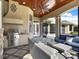 Inviting outdoor kitchen with stainless steel grill and a covered patio with comfortable seating at 11306 Bridge House Rd, Windermere, FL 34786