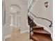 Elegant staircase with wrought iron railing and wood steps, leading to an arched doorway at 11306 Bridge House Rd, Windermere, FL 34786