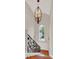Staircase featuring a wrought iron railing, decorative sconces, and a large arched window at 11306 Bridge House Rd, Windermere, FL 34786