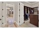Spacious walk-in closet with custom built-in shelving and convenient access to bathroom at 11306 Bridge House Rd, Windermere, FL 34786