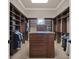 Large walk-in closet with built-in custom cabinetry and a central island at 11306 Bridge House Rd, Windermere, FL 34786