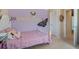 Cozy bedroom featuring a purple accent wall with playful decorations and a matching bed set at 12189 Beach Fern Rd, Orlando, FL 32824