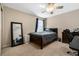 Bedroom featuring a large window with a fan, a full-length mirror, and a wooden desk at 12189 Beach Fern Rd, Orlando, FL 32824