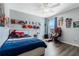 bedroom with a gaming chair and a bed with Superhero-themed decorations at 12189 Beach Fern Rd, Orlando, FL 32824