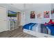 Bedroom featuring a large bed, ceiling fan, and a wall-mounted TV near a white closet door at 12189 Beach Fern Rd, Orlando, FL 32824
