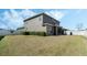 Exterior shot of house showing its spacious lawn, landscaping, and screened-in porch at 12189 Beach Fern Rd, Orlando, FL 32824