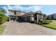 Charming two-story home featuring stone accents, three-car garage and brick paver driveway at 12189 Beach Fern Rd, Orlando, FL 32824