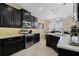 Modern kitchen featuring stainless steel appliances, stone backsplash, black cabinetry and pendant lighting at 12189 Beach Fern Rd, Orlando, FL 32824