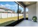 View from the lanai to the fenced yard and green grass at 12189 Beach Fern Rd, Orlando, FL 32824
