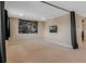 Neutral-toned living room with carpet, recessed lighting, a large wall print, and a wall-mounted TV at 12189 Beach Fern Rd, Orlando, FL 32824