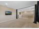 Spacious carpeted living room area offering neutral decor, recessed lighting, and a large wall-mounted television at 12189 Beach Fern Rd, Orlando, FL 32824