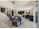 Bright living room features high ceilings, an open layout, tile floors, and a gray sectional couch at 12189 Beach Fern Rd, Orlando, FL 32824
