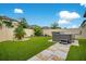 Well-maintained backyard with artificial turf, stone pathway, and a luxurious hot tub for relaxation at 13227 Spring Grove Way, Winter Garden, FL 34787
