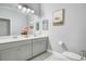 Bathroom featuring double vanity and a white toilet and colorful elephant artwork at 13227 Spring Grove Way, Winter Garden, FL 34787