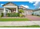 Beautiful two-story home featuring a two-car garage, manicured lawn, and brick paved driveway at 13227 Spring Grove Way, Winter Garden, FL 34787