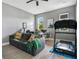 Home office space with a large sofa, desk setup, and treadmill for exercise at 13227 Spring Grove Way, Winter Garden, FL 34787