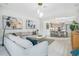 Open-concept living room with stylish decor and seamless flow into the adjacent dining and kitchen areas at 13227 Spring Grove Way, Winter Garden, FL 34787