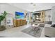 Bright and spacious living room featuring a modern entertainment center and light wood floors at 13227 Spring Grove Way, Winter Garden, FL 34787