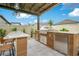 Outdoor kitchen with stainless steel grill, refrigerator, and granite countertops for outdoor entertainment at 13227 Spring Grove Way, Winter Garden, FL 34787