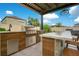 Outdoor kitchen features a built-in grill and bar seating, ideal for entertaining in style at 13227 Spring Grove Way, Winter Garden, FL 34787