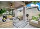 Relaxing outdoor living area with ceiling fan and comfortable seating, perfect for entertaining or enjoying a quiet evening at 13227 Spring Grove Way, Winter Garden, FL 34787
