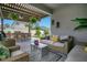 Inviting outdoor living space with a built-in bar and comfortable seating under a stylish pergola at 13227 Spring Grove Way, Winter Garden, FL 34787
