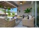 Inviting outdoor living area with comfortable seating, hanging plants, and a fan at 13227 Spring Grove Way, Winter Garden, FL 34787
