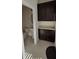 Bathroom with built-in dark wood cabinets and a pedestal sink at 15471 Honeybell Dr, Winter Garden, FL 34787