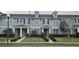 A well-maintained townhome with a landscaped front yard and a symmetrical facade with modern fixtures at 15471 Honeybell Dr, Winter Garden, FL 34787