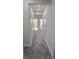 Hallway with carpet floors and neutral paint leads to bedrooms and bathrooms at 15471 Honeybell Dr, Winter Garden, FL 34787