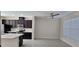 A modern kitchen features stainless steel appliances, dark wood cabinets, and an eat-in area with tile floors at 15471 Honeybell Dr, Winter Garden, FL 34787
