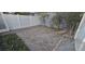 Private brick patio area surrounded by a white fence and manicured landscaping at 15471 Honeybell Dr, Winter Garden, FL 34787