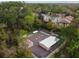 Aerial view of the community recreation area, surrounded by trees, with bocce ball and shuffleboard courts at 170 Palmetto Woods Ct # 3A, Deltona, FL 32725