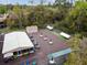 Aerial view of the recreation area featuring covered bocce ball, shuffleboard, and tables with umbrellas at 170 Palmetto Woods Ct # 3A, Deltona, FL 32725
