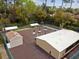 Aerial view of the community recreational area with bocce ball, shuffleboard, tables, and a small building at 170 Palmetto Woods Ct # 3A, Deltona, FL 32725