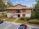 Exterior view of the home, with parking and neatly maintained landscaping at 170 Palmetto Woods Ct # 3A, Deltona, FL 32725