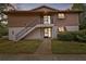 Inviting two-story exterior featuring well-maintained siding, trimmed bushes, and a staircase leading to the upper level entrance at 170 Palmetto Woods Ct # 3A, Deltona, FL 32725