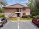 Exterior view of home with parking, stairs, and shrubbery at 170 Palmetto Woods Ct # 3A, Deltona, FL 32725