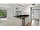 Modern kitchen features an open design, granite countertops, a stainless steel dishwasher, and a view of the open living area at 170 Palmetto Woods Ct # 3A, Deltona, FL 32725