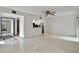 Bright living room featuring sleek tile flooring, ample space, and a view into the modern kitchen with granite countertop at 170 Palmetto Woods Ct # 3A, Deltona, FL 32725