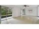 Open living room with tile floors, ceiling fan, and sliding doors that bring in natural light and outdoor views at 170 Palmetto Woods Ct # 3A, Deltona, FL 32725