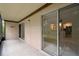 Wide, screened patio with tile floors and view of kitchen inside at 170 Palmetto Woods Ct # 3A, Deltona, FL 32725