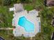 Top-down aerial shot of a sparkling community pool with plenty of lounge seating and tables at 170 Palmetto Woods Ct # 3A, Deltona, FL 32725