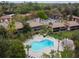 Aerial view of a community pool and lounge area surrounded by palm trees and condominium buildings at 170 Palmetto Woods Ct # 3A, Deltona, FL 32725