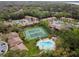 Overhead shot featuring community tennis courts and swimming pool area surrounded by lush trees and condos at 170 Palmetto Woods Ct # 3A, Deltona, FL 32725