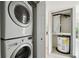 Image of stacked washer and dryer along with water heater in a utility closet at 170 Palmetto Woods Ct # 3A, Deltona, FL 32725