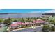 An aerial view displays the stunning community clubhouse next to a large beautiful lake at 200 Snowy Orchid Way, Lake Alfred, FL 33850