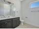 Bathroom features a double sink vanity, modern fixtures, and great lighting at 200 Snowy Orchid Way, Lake Alfred, FL 33850