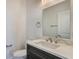 Powder room with modern vanity, fixtures, and decorative mirror at 200 Snowy Orchid Way, Lake Alfred, FL 33850